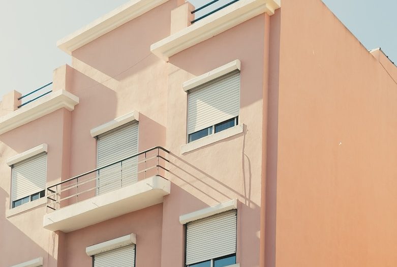 a pink building with balconies and balconies on the balconies