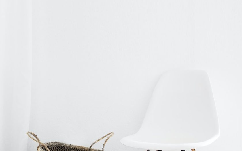 white and brown chairs beside wicker basket near white wall