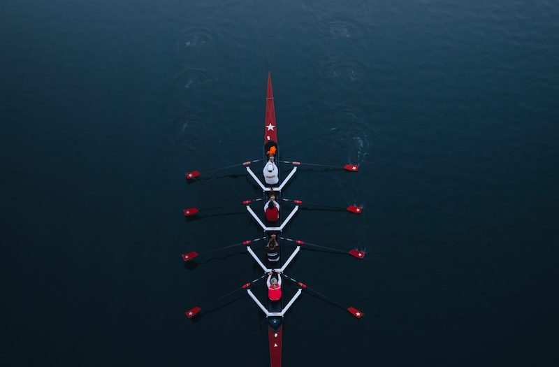 a row of boats floating on top of a body of water