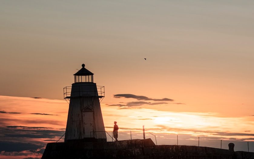 a light house sitting on top of a body of water