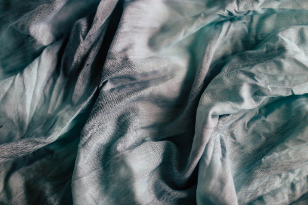 teal and grey textile