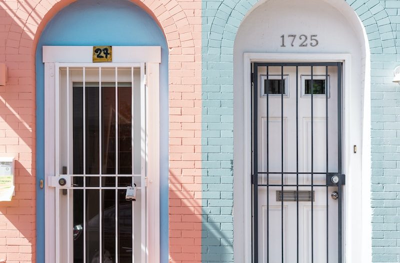 two white wooden doors with grills