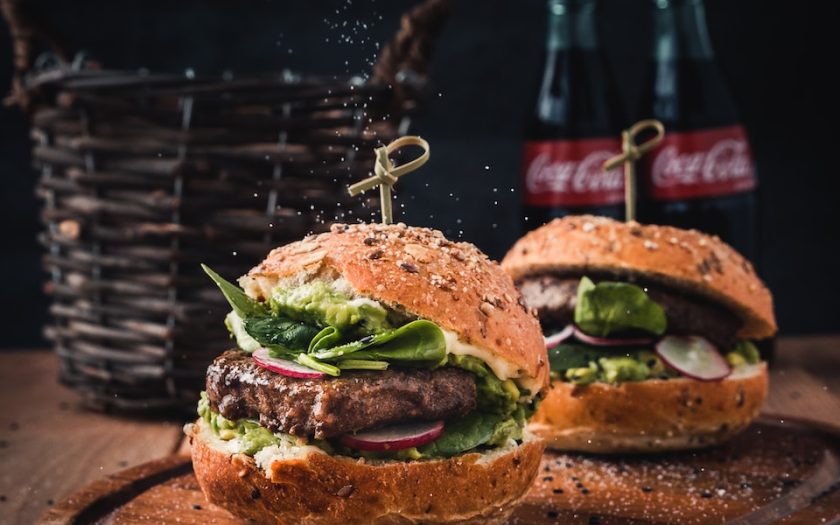 burger with vegetable on brown wooden tray