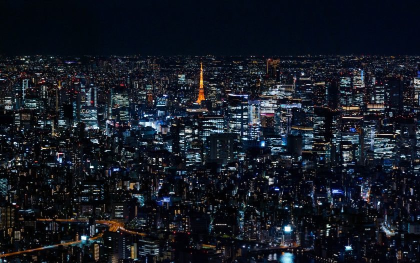 a view of a city at night from the top of a skyscraper