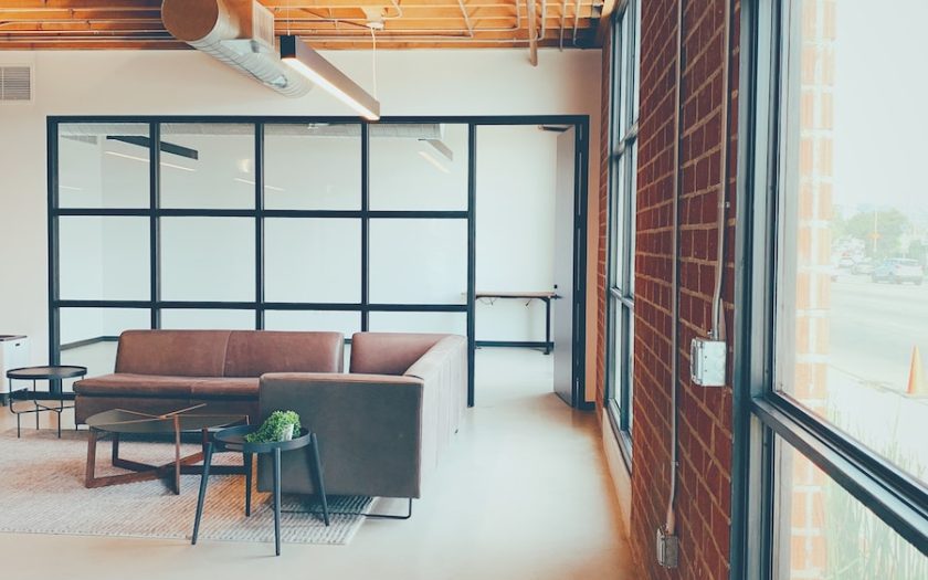 a room with a couch and chairs