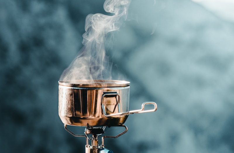 a pot on a burner with smoke coming out of it