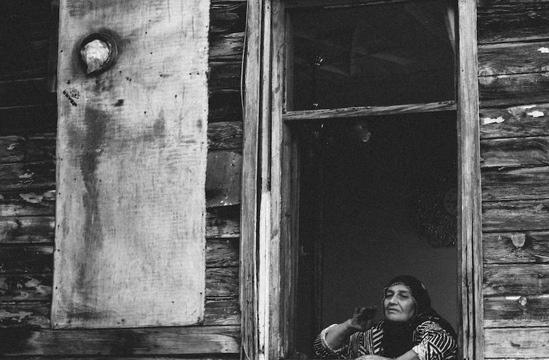 woman standing beside window