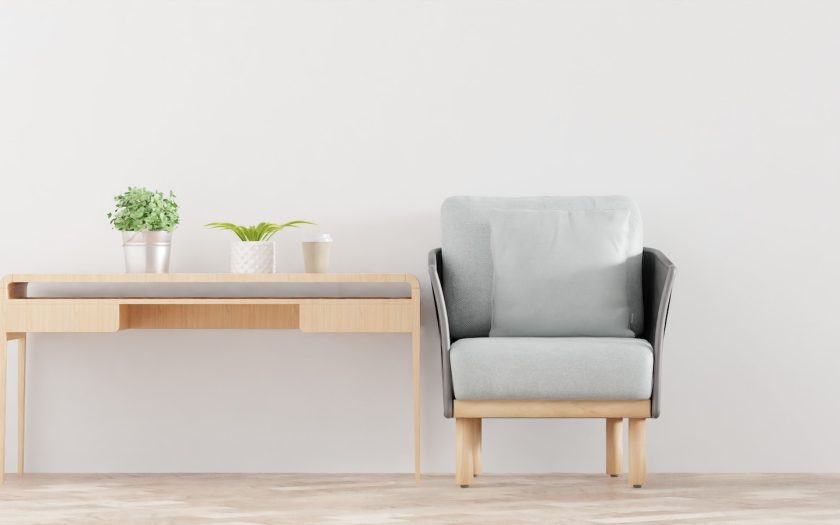 a chair next to a table with a potted plant on it