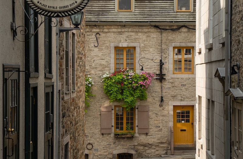 a stone building with a yellow door and window