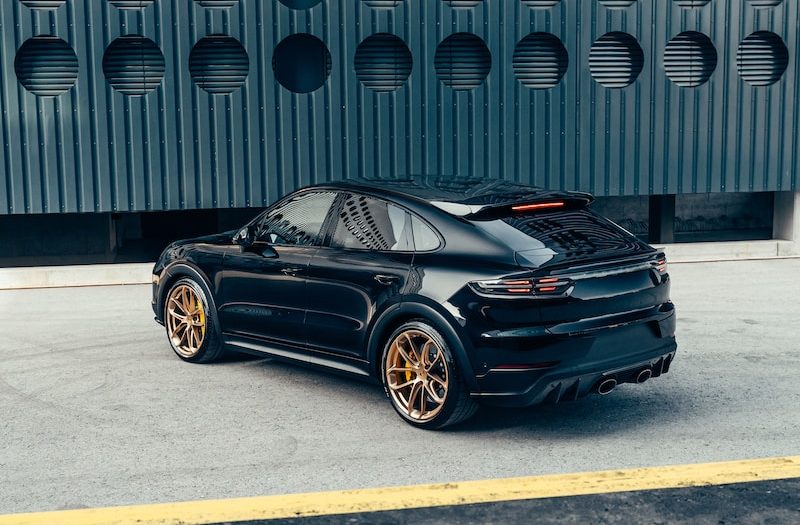 a black sports car parked in front of a building