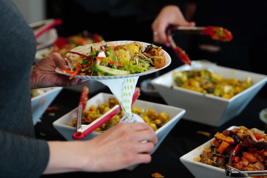 person holding white ceramic bowl with food